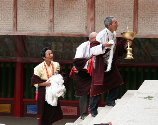 fedeli buddisti portano offerte in un tempio del Monastero di Labrang a Xiahe nel Qinghai cinese